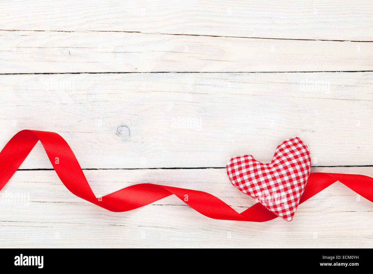 Valentines day toy heart and ribbon over wooden table background with ...