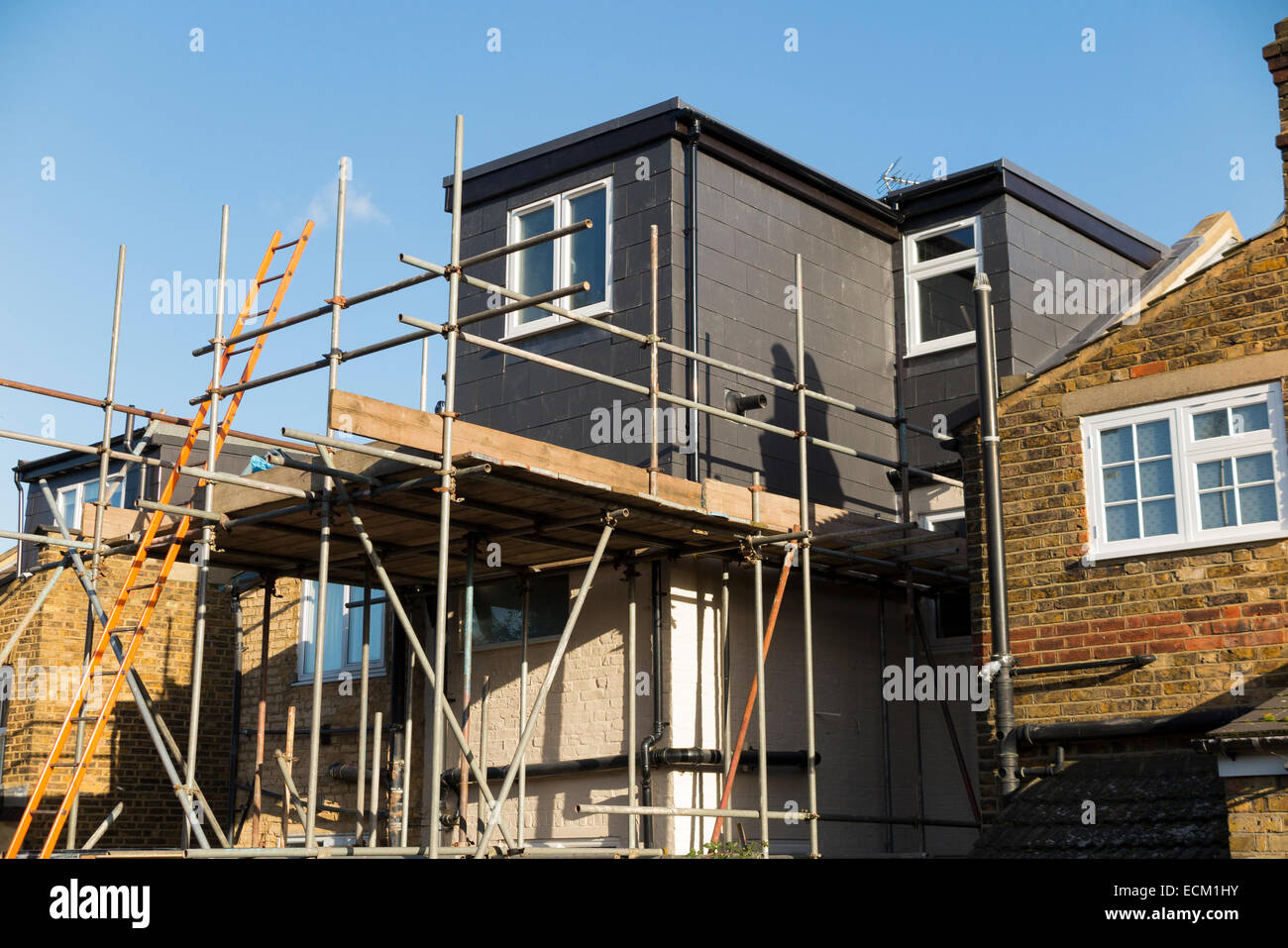 Scaffolding to a newly completed dormer / dormers / dormas / dorm on the roof on a Victorian terraced house in Twickenham. UK Stock Photo