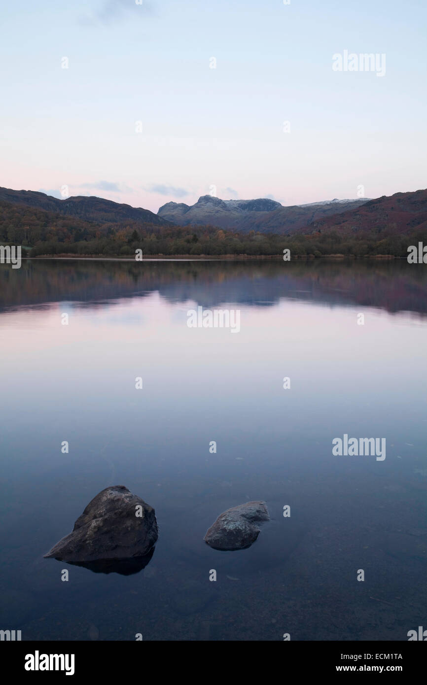 Langdale Pikes reflected in Elter Water Lake at dawn in the English Lake District Stock Photo