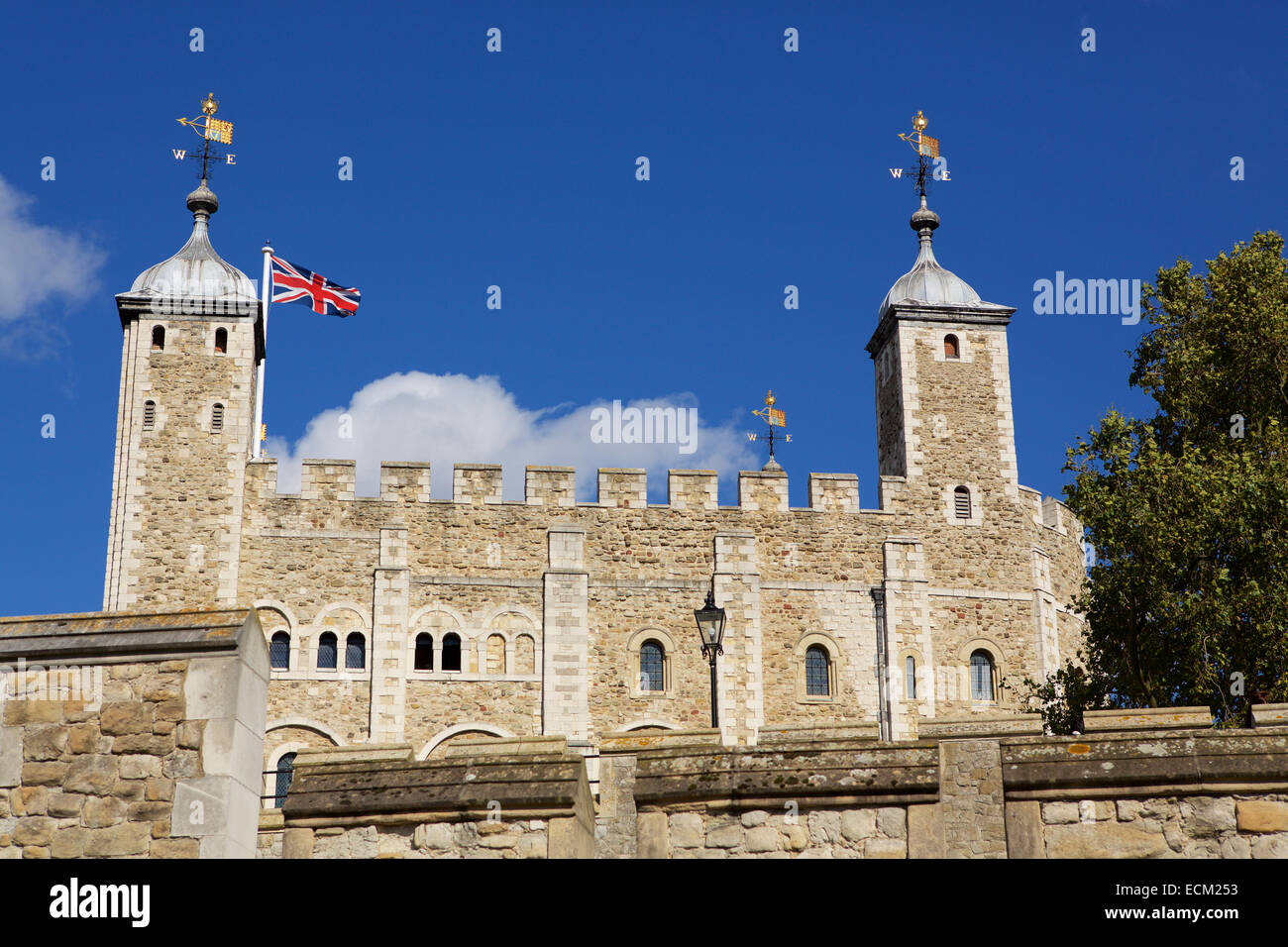 The tower of London. Famous view of the tower; the Union Flag flying on the tower against a blue sky. Stock Photo