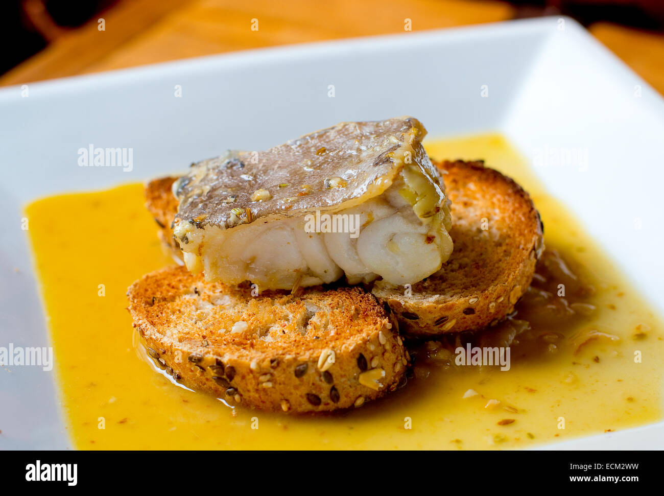 Typical spanish codfish tapa cooked at low temperature. Stock Photo