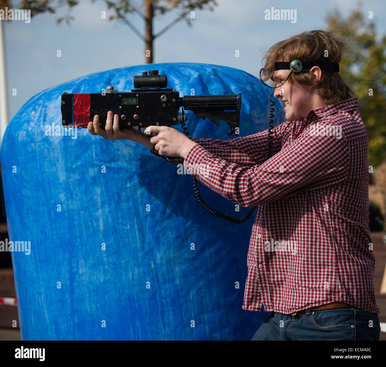 Cartoon man playing laser tag game holding a gun and walking Stock