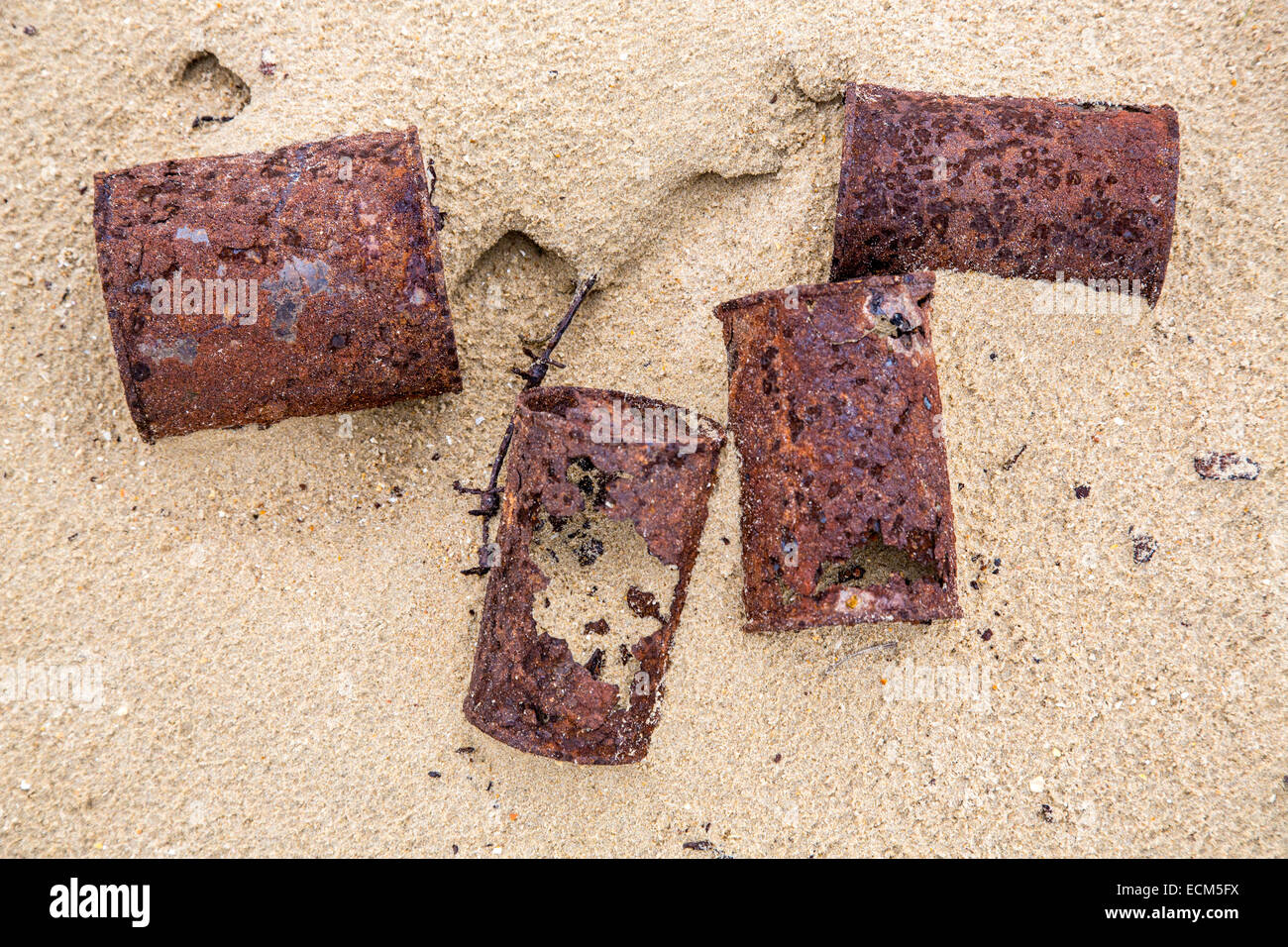 Rusty, old tin cans on a sandy beach, Stock Photo