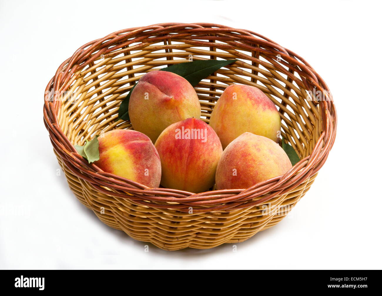 Basket with peaches on white background Stock Photo - Alamy