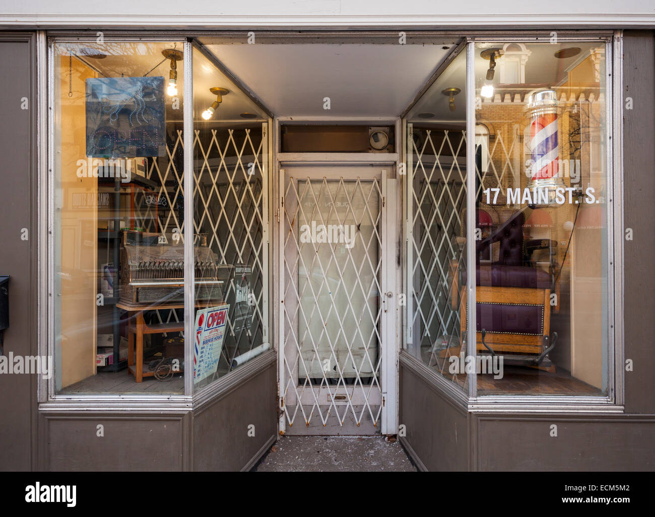 A traditional barber shop with antique furniture in the window