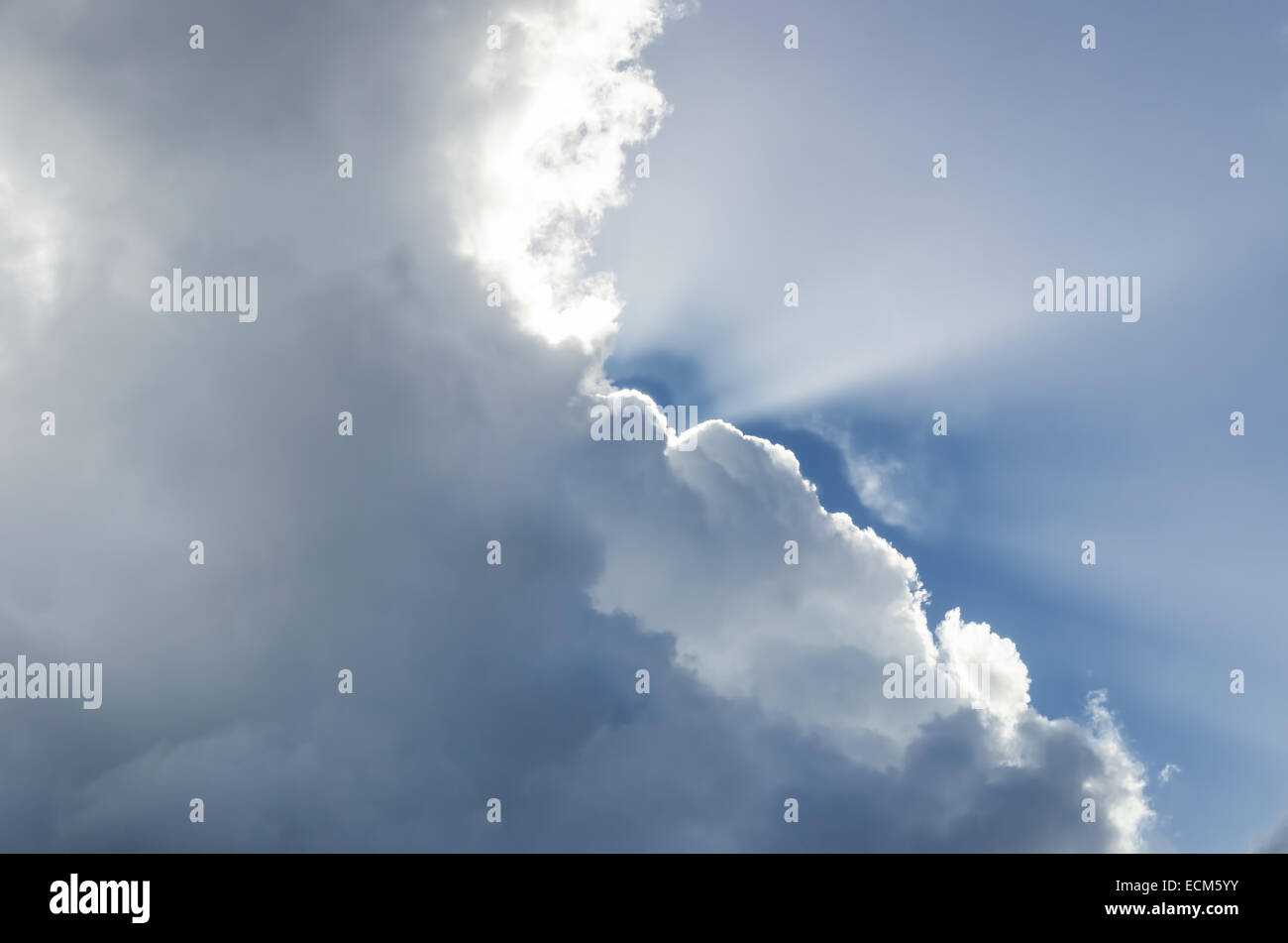 Sun rays striking through clouds Stock Photo