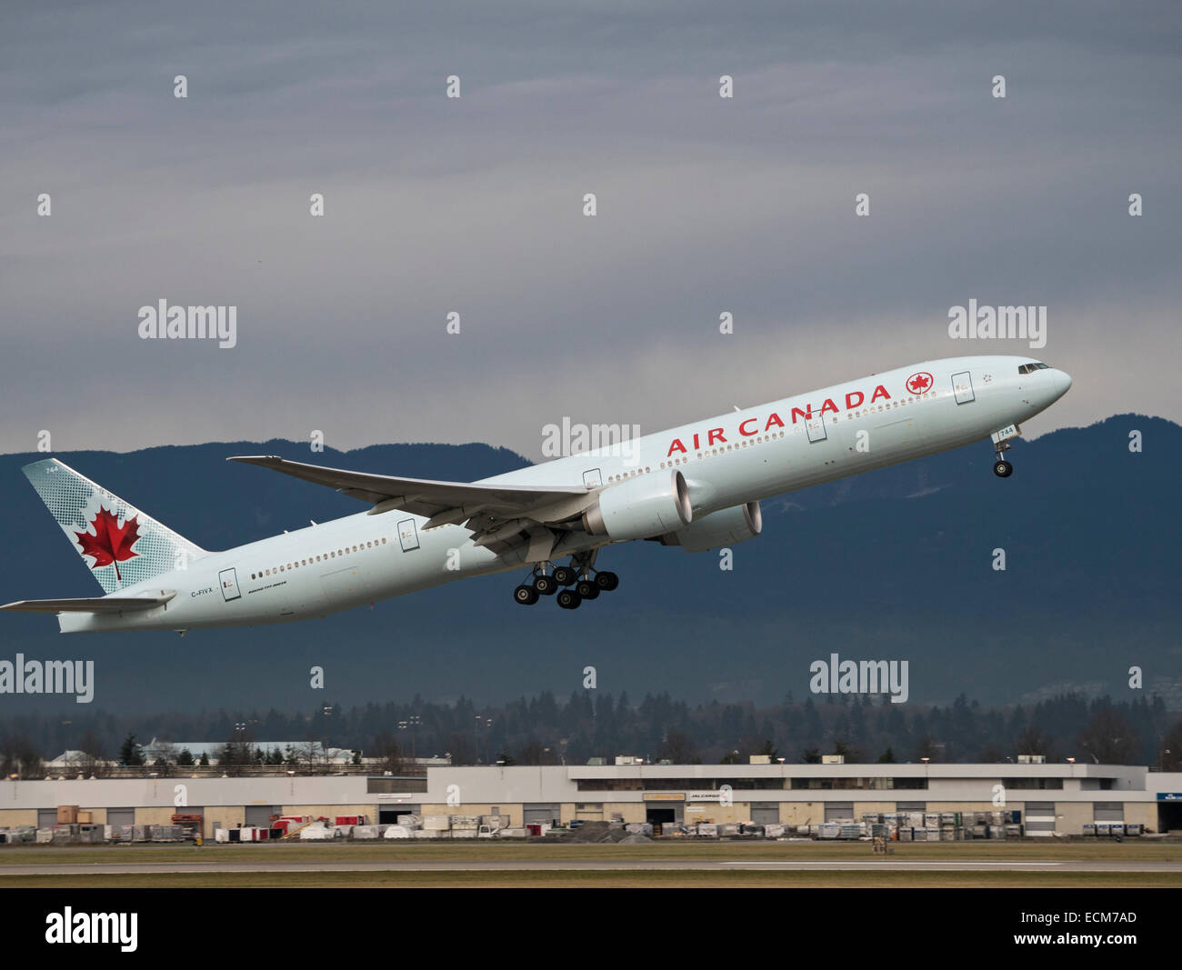 An Air Canada Boeing 777-300ER (C-FIVX; Fin#744) jetliner departs from Vancouver International Airport, Canada Stock Photo