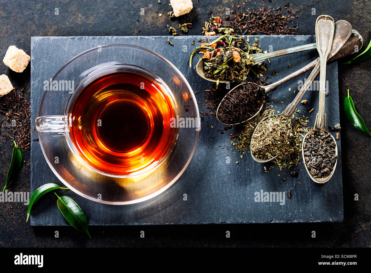 Tea composition with old spoon on dark background Stock Photo - Alamy