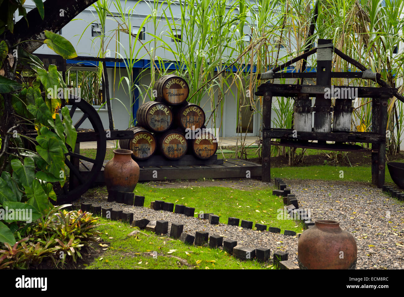 Antique barrels and equipment at the front of the Brugal Rum factory in Puerto Plata Dominican Republic Stock Photo