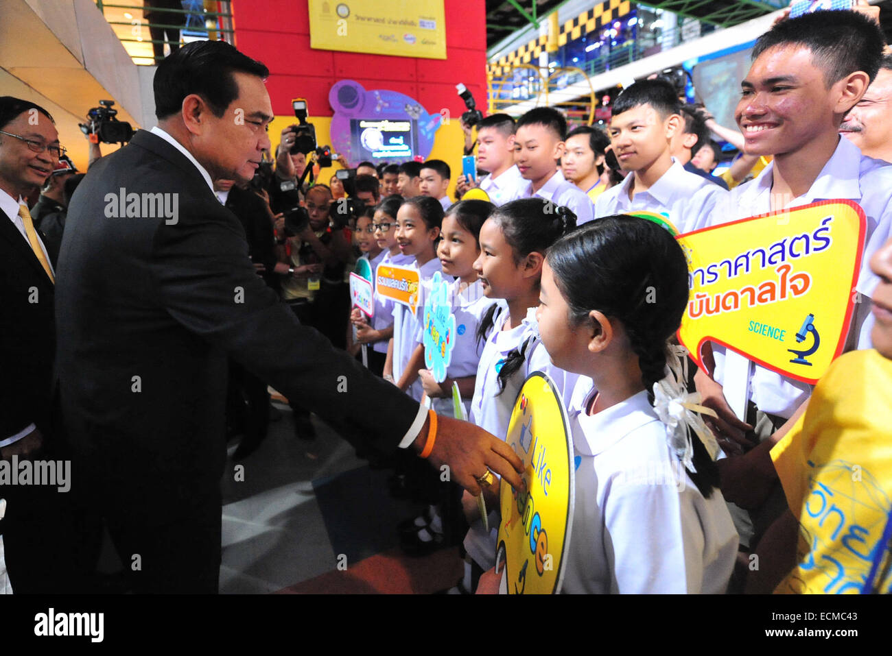 Bangkok, Thailand. 17th Dec, 2014. Thai Prime Minister Gen. Prayuth Chan-ocha (2nd, L) greets children during his visit to the Science Center for Education in Bangkok, Thailand, Dec. 17, 2014. Credit:  Rachen Sageamsak/Xinhua/Alamy Live News Stock Photo