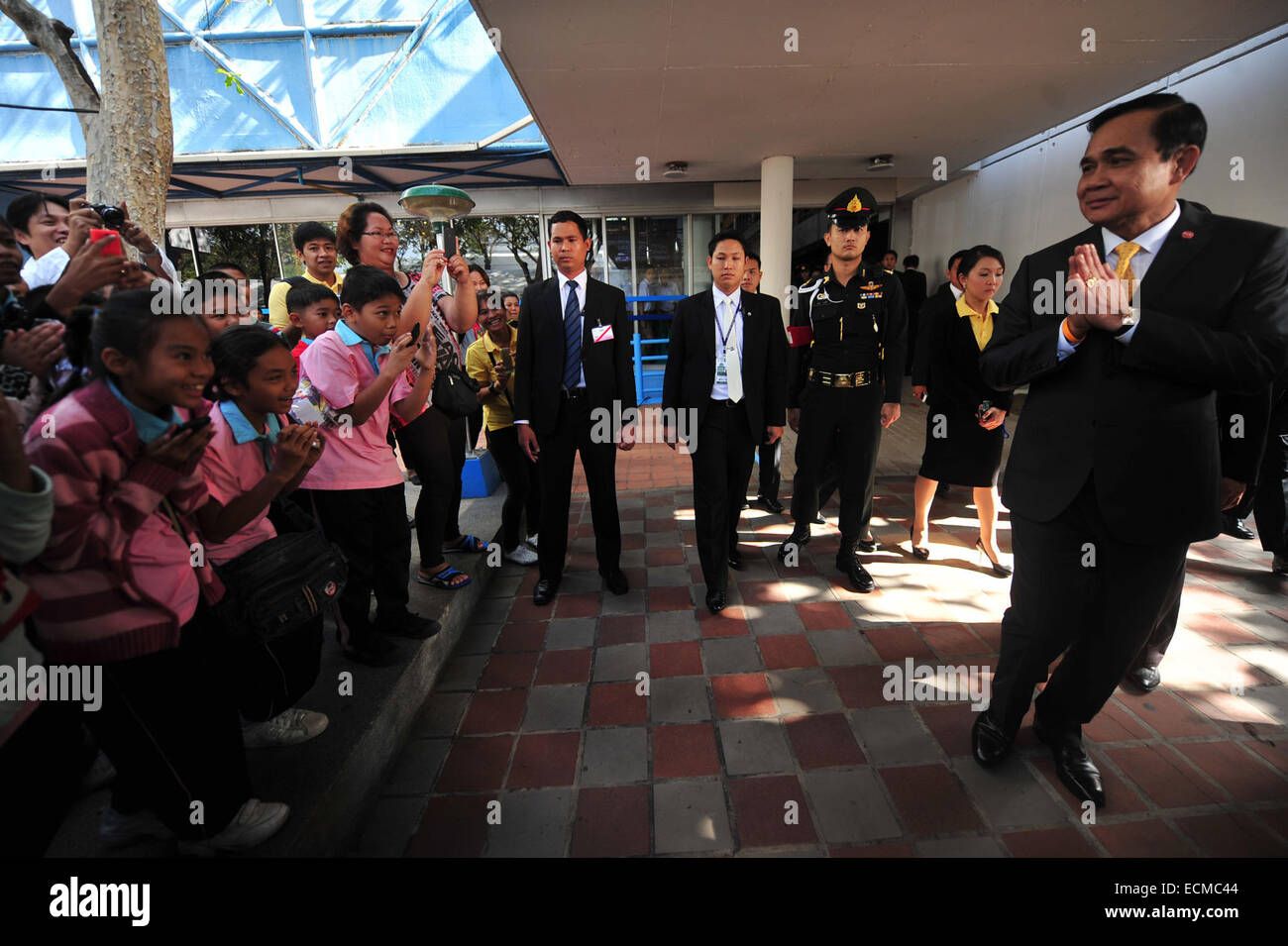 Bangkok, Thailand. 17th Dec, 2014. Thai Prime Minister Gen. Prayuth Chan-ocha (R) greets children during his visit to the Science Center for Education in Bangkok, Thailand, Dec. 17, 2014. Credit:  Rachen Sageamsak/Xinhua/Alamy Live News Stock Photo