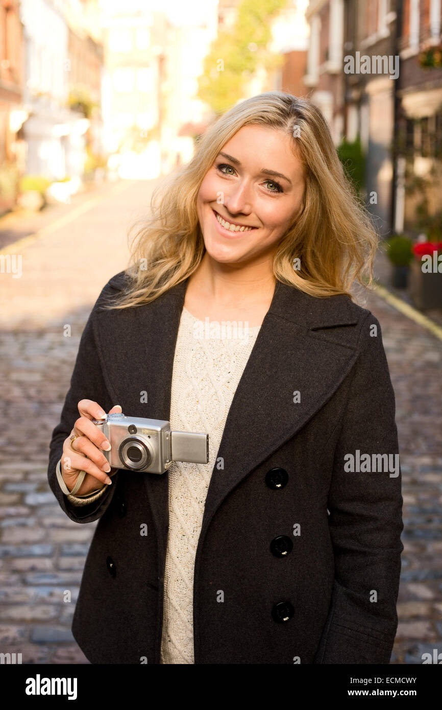 young woman holding a camera Stock Photo