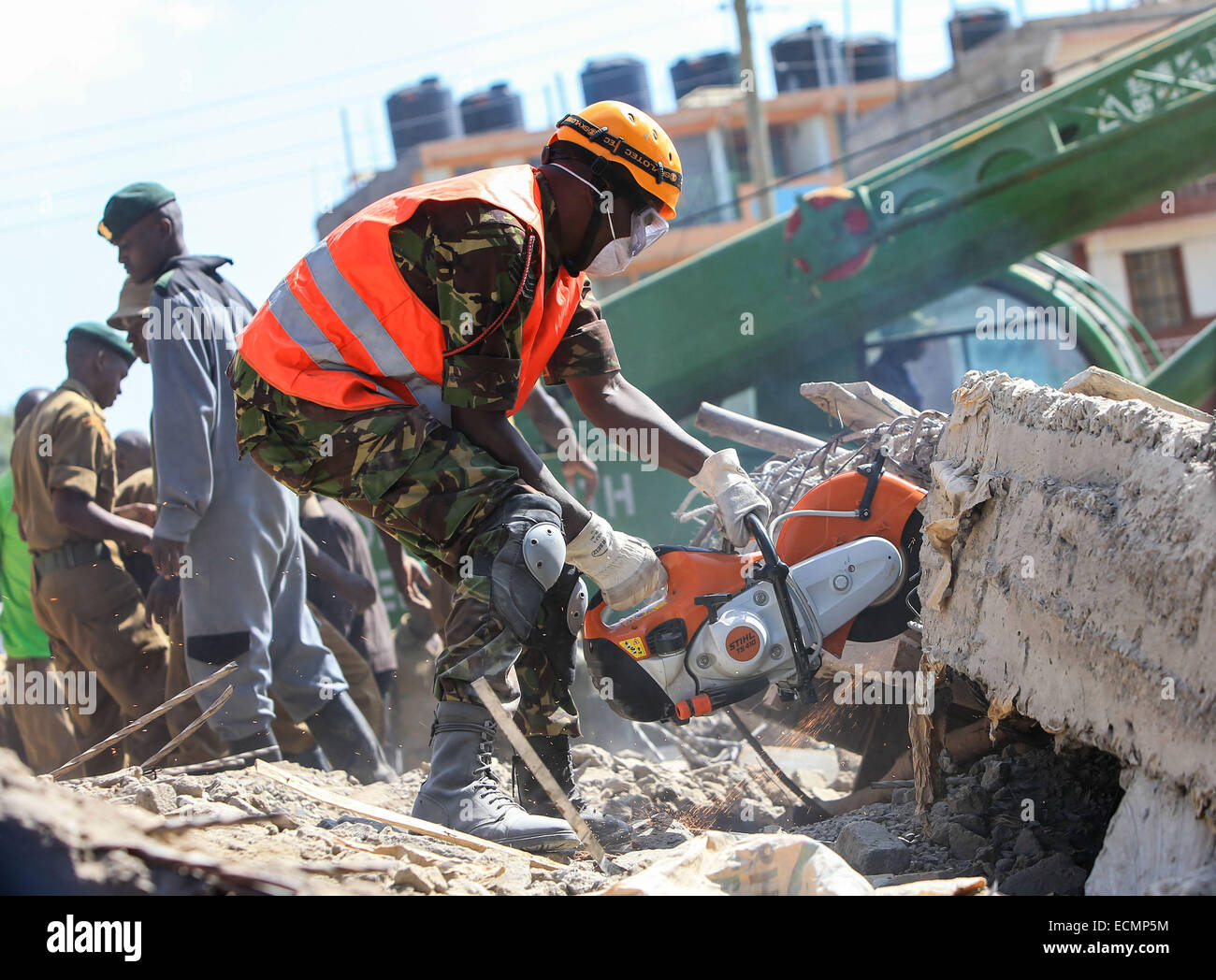 Nairobi, Kenya. 17th Dec, 2014. A rescuer tries to cut floorslab of a collapsed residential building in Nairobi, capital of Kenya, Dec. 17, 2014. According to Kenya Red Cross staff, the building collapsed at around 2 a.m. on Wednesday. The number of people get trapped is unconfirmed. Rescue work is still underway. Credit:  Meng Chenguang/Xinhua/Alamy Live News Stock Photo
