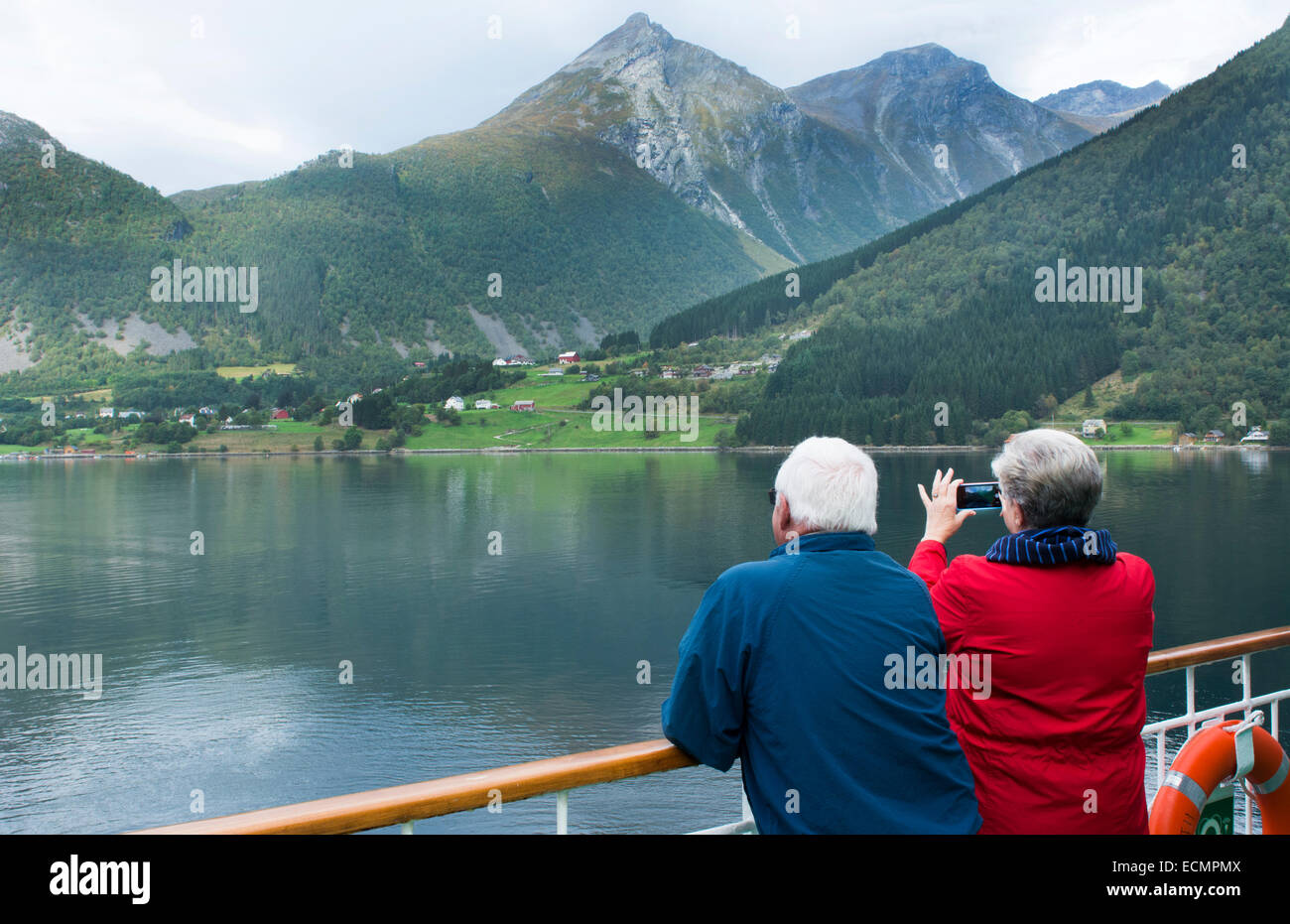 Norway Cruise Hurtigruten Ship Fjord Woman Taking Photo Of Scenic From Balcony With Old Norway Postal Flag In Hjorundjorden Mr 1 Stock Photo Alamy