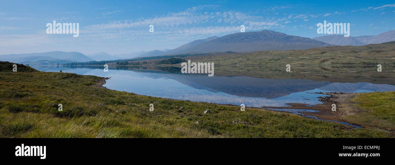 A mirror-smooth Loch Tulla reflects the Scottish Highlands in all their early autumn glory Stock Photo