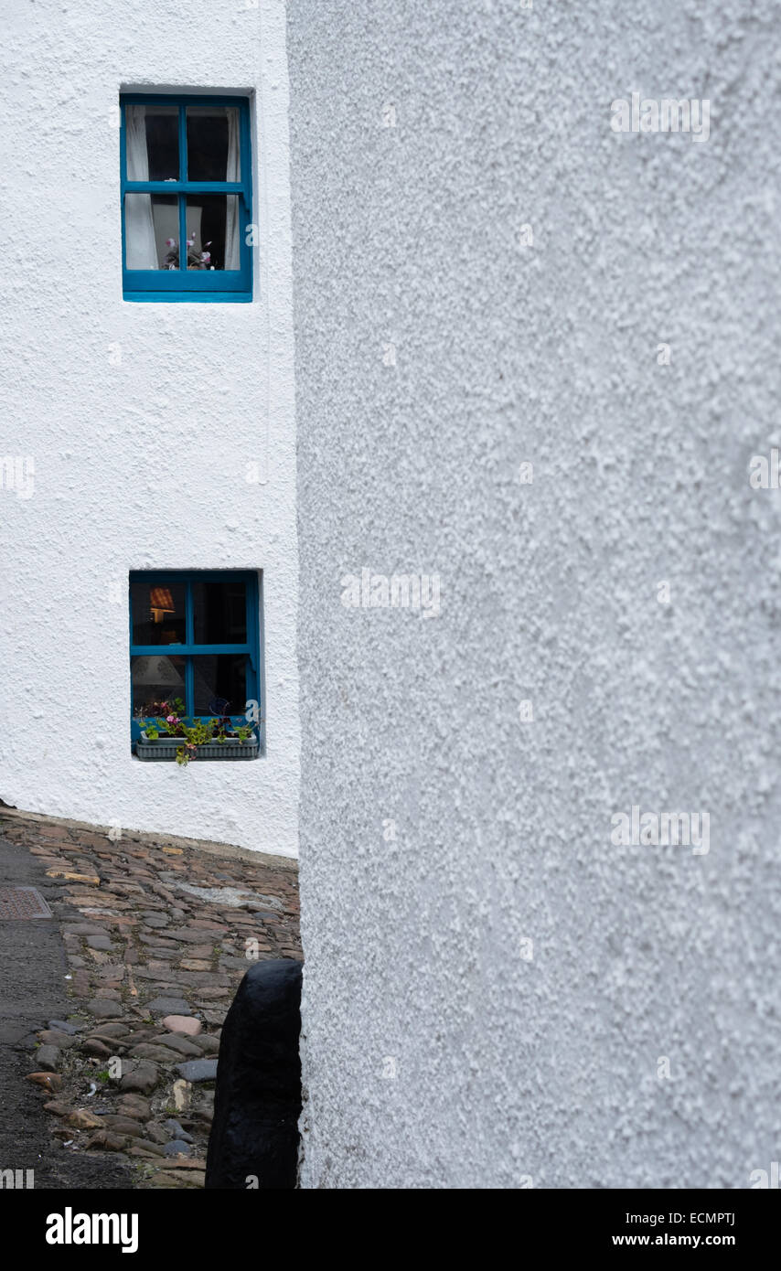 Two blue painted windows stand out against white painted walls of fishermen's cottages in Crail, East Neuk, Fife, Scotland Stock Photo