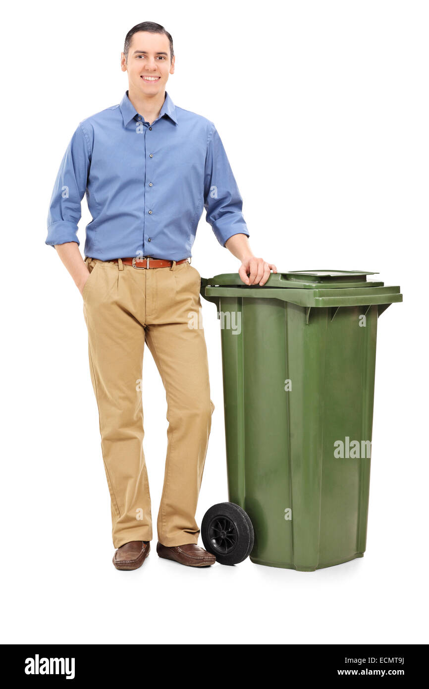 https://c8.alamy.com/comp/ECMT9J/full-length-portrait-of-a-young-man-standing-by-a-large-green-trash-ECMT9J.jpg