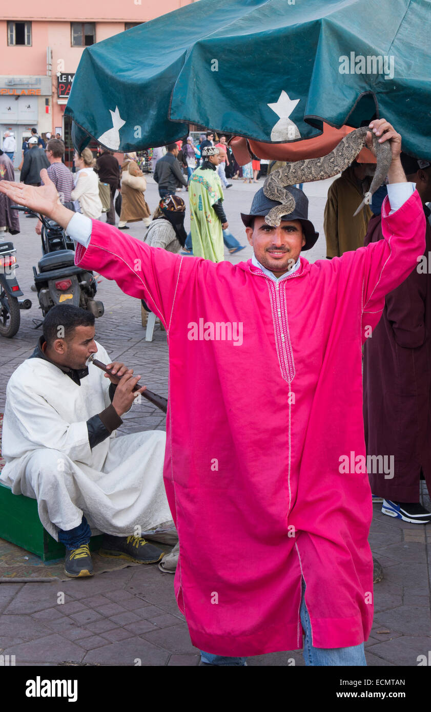 Marrakech Morocco traditional snake charmers in Old Medina with snakes in pink robe Stock Photo