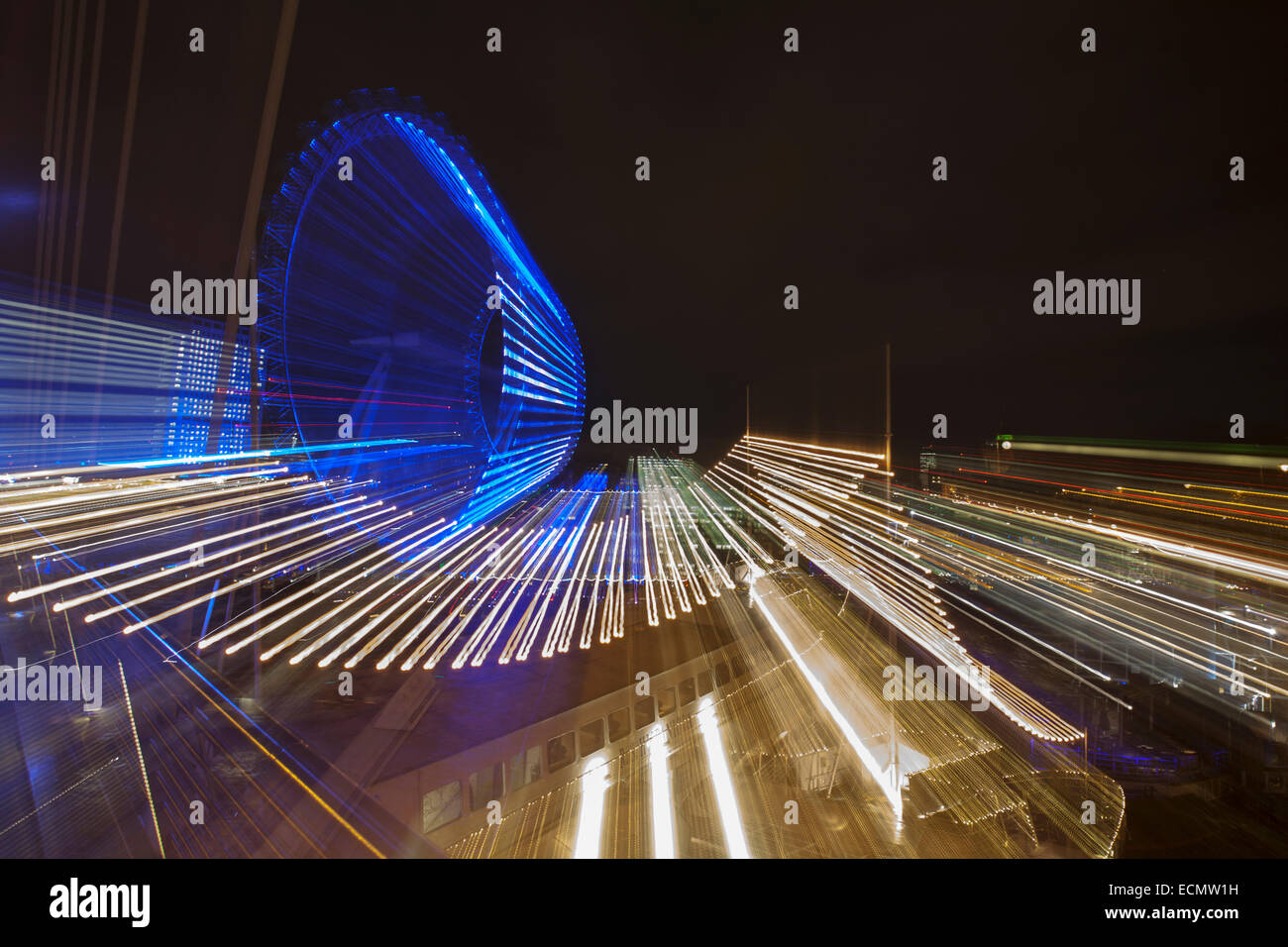 Zoomburst of London Eye and tourist boat with hanging lights on the River Thames at London UK in December - abstract effect Stock Photo
