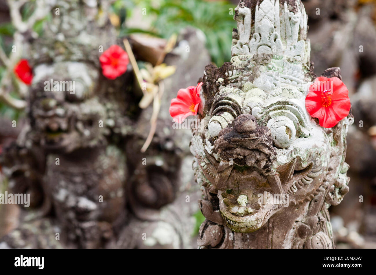 Some of the Hindu stone statues decorating the temple Pura Desa Ubud. Ubud. Bali. The Ubud Monkey Forest is a nature reserve and Stock Photo