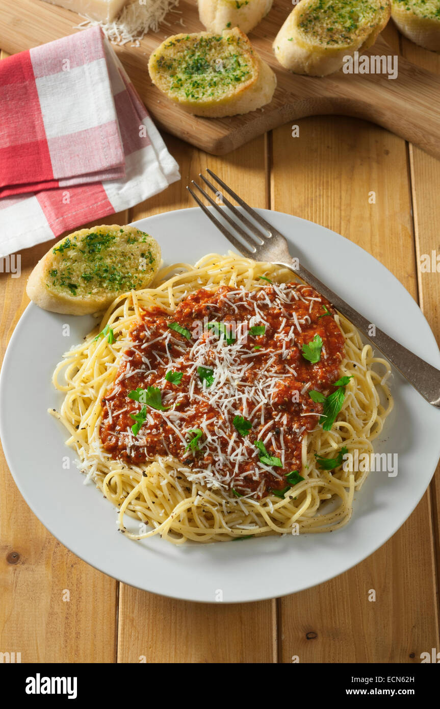 Spaghetti bolognese with garlic bread. Italian pasta dish. Stock Photo