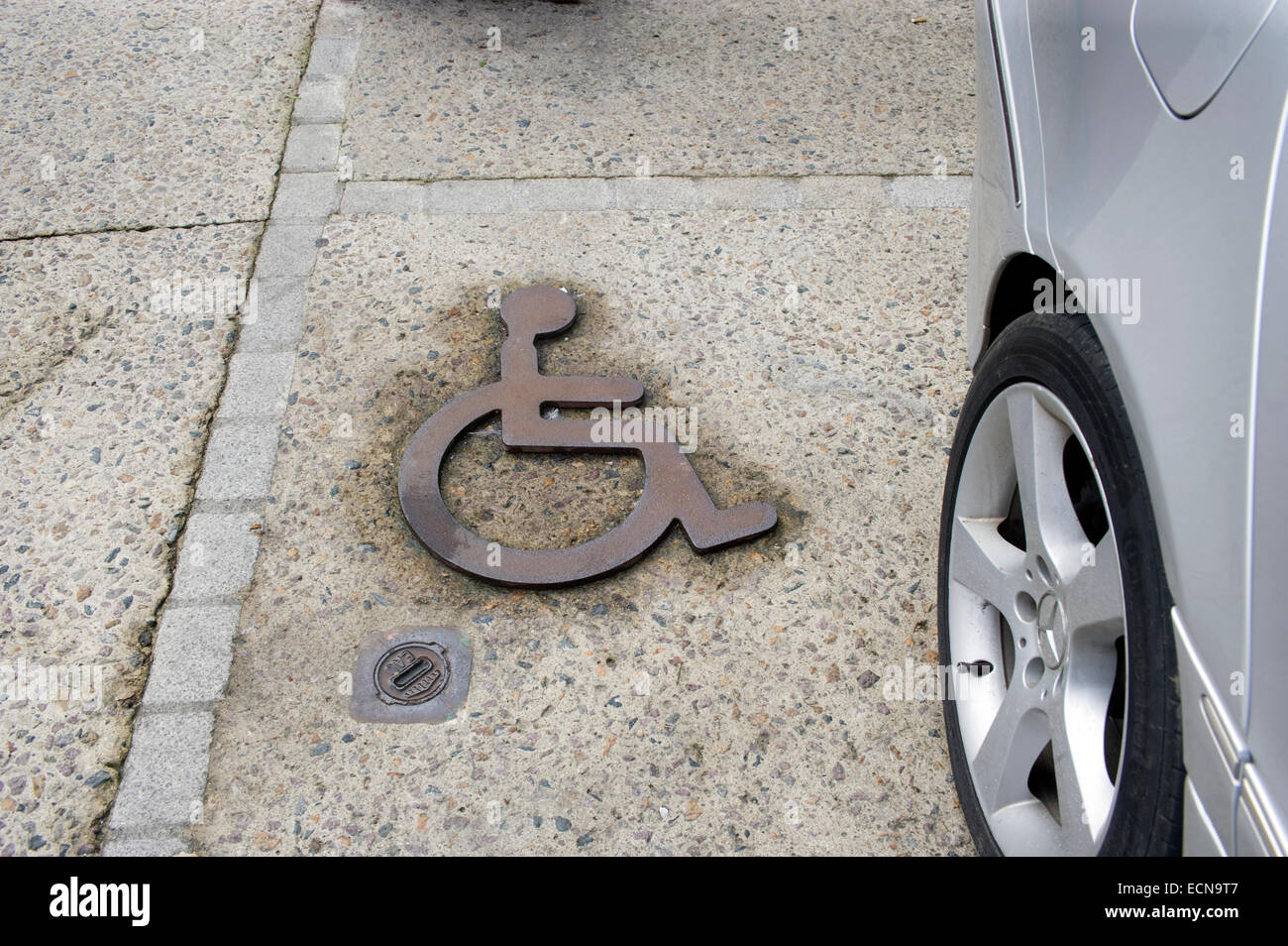 Disabled parking sign, cast iron set in stone Stock Photo