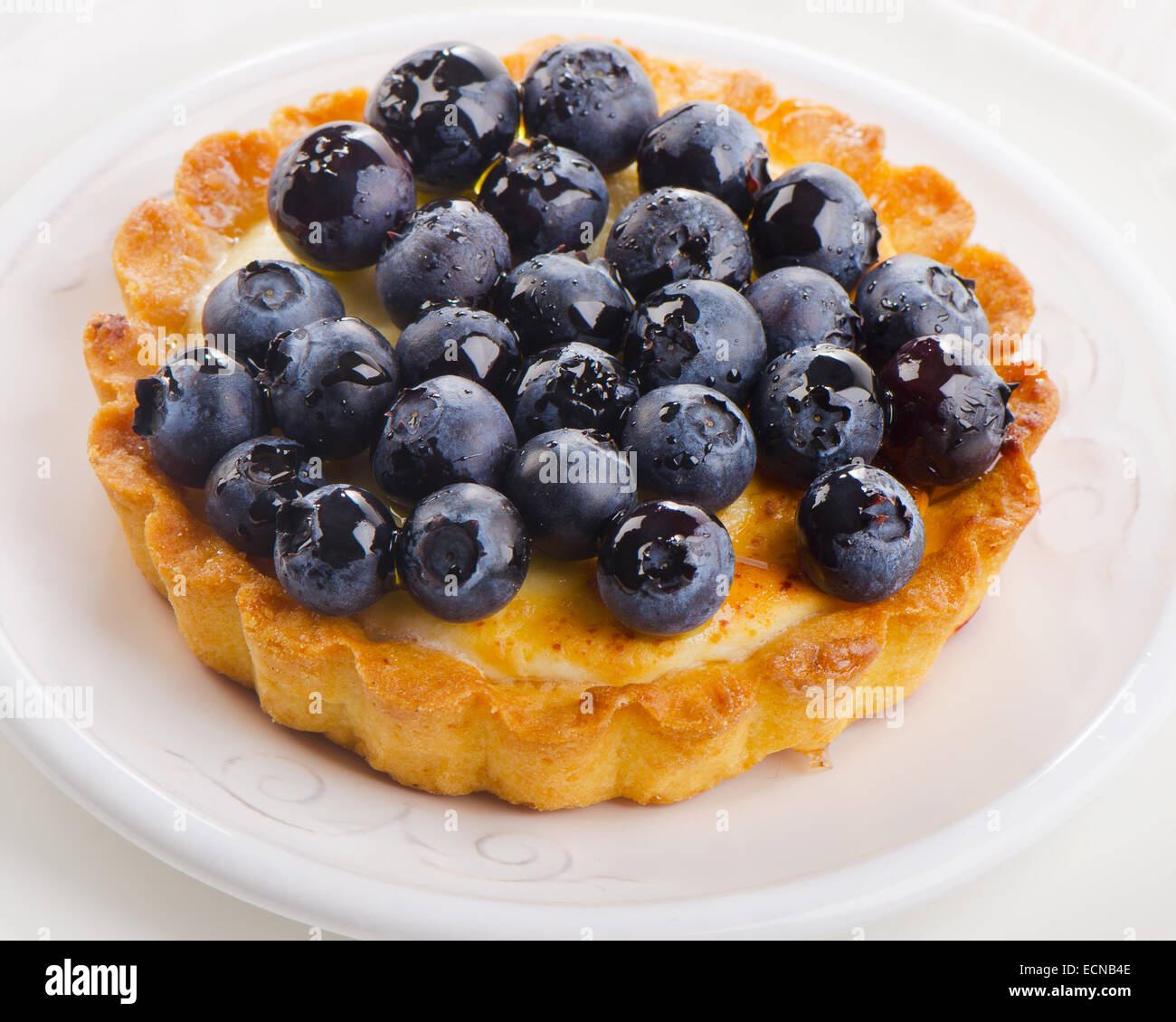 Fresh Blueberry tart on a white plate. Selective focus Stock Photo