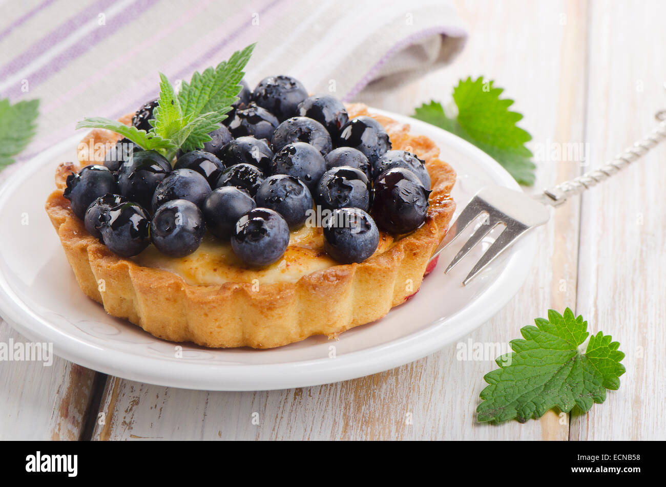 Fresh Blueberry tart on a white plate. Selective focus Stock Photo