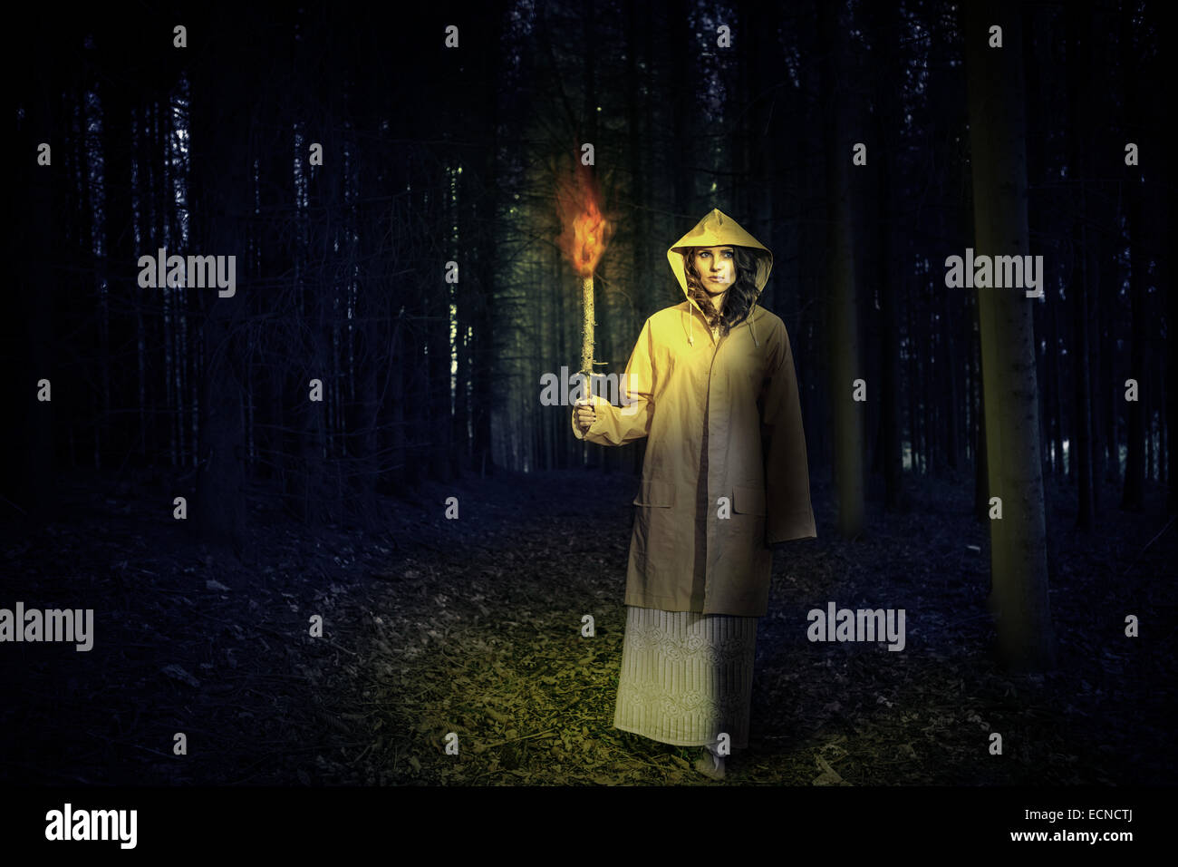 an outdoor portrait of a young mystic woman in the dark forest.  Book cover style. Stock Photo