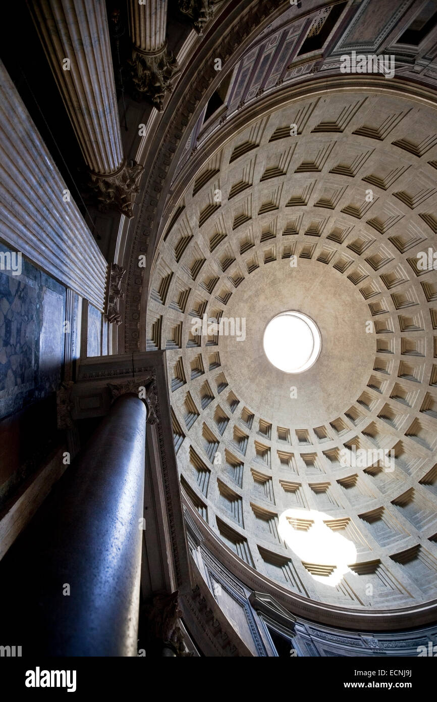 Beam of light through the oculus of the geometric concrete ceiling of the Pantheon Rome, Italy Stock Photo