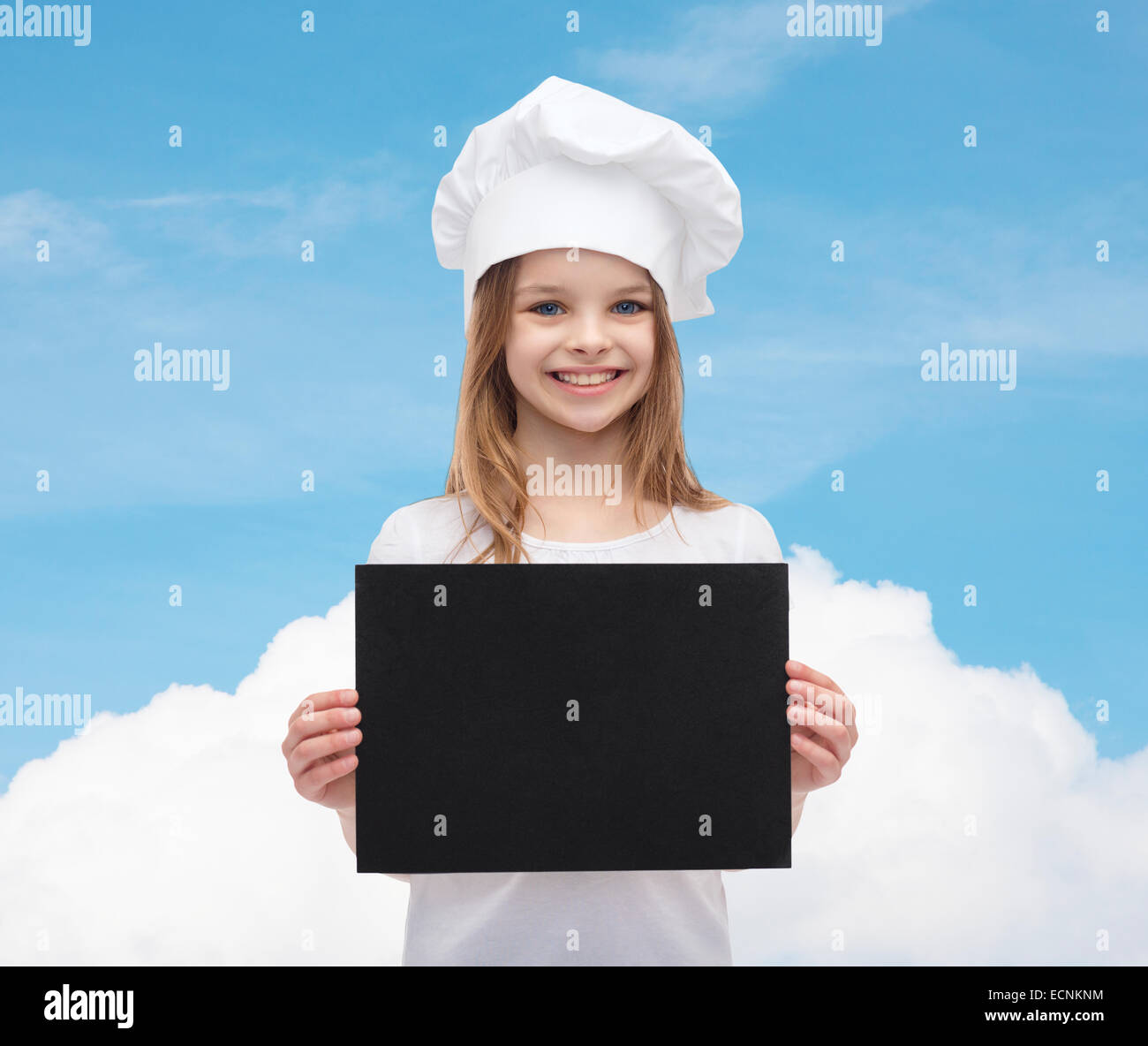 little cook or baker with blank black paper Stock Photo