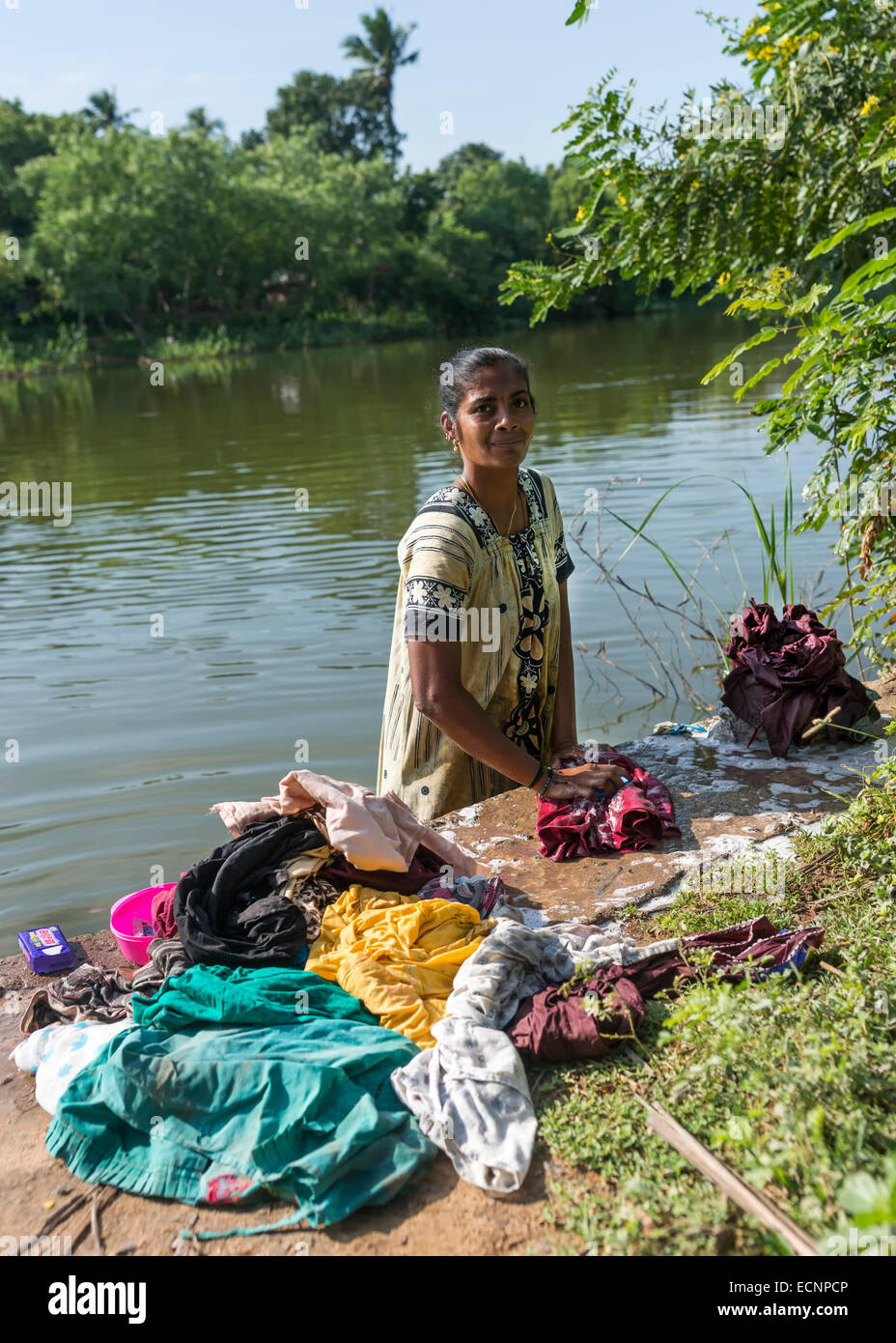Woman does the laundry standing in the river Stock Photo - Alamy