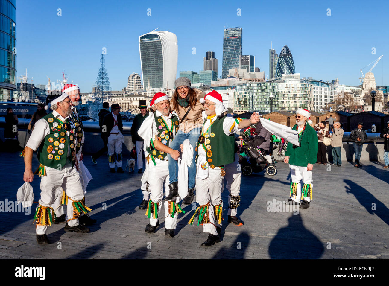 A Female Italian Tourist Is Held Aloft After Dancing With The North Wood Morris Men Outside City Hall, London, England Stock Photo
