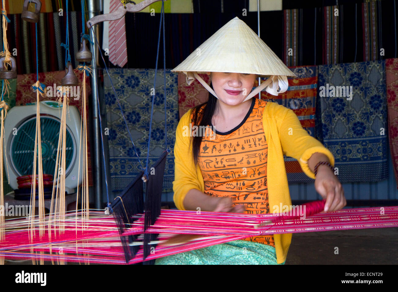 Vietnamese woman weaving silk into cloth near Da Lat, Vietnam. Stock Photo
