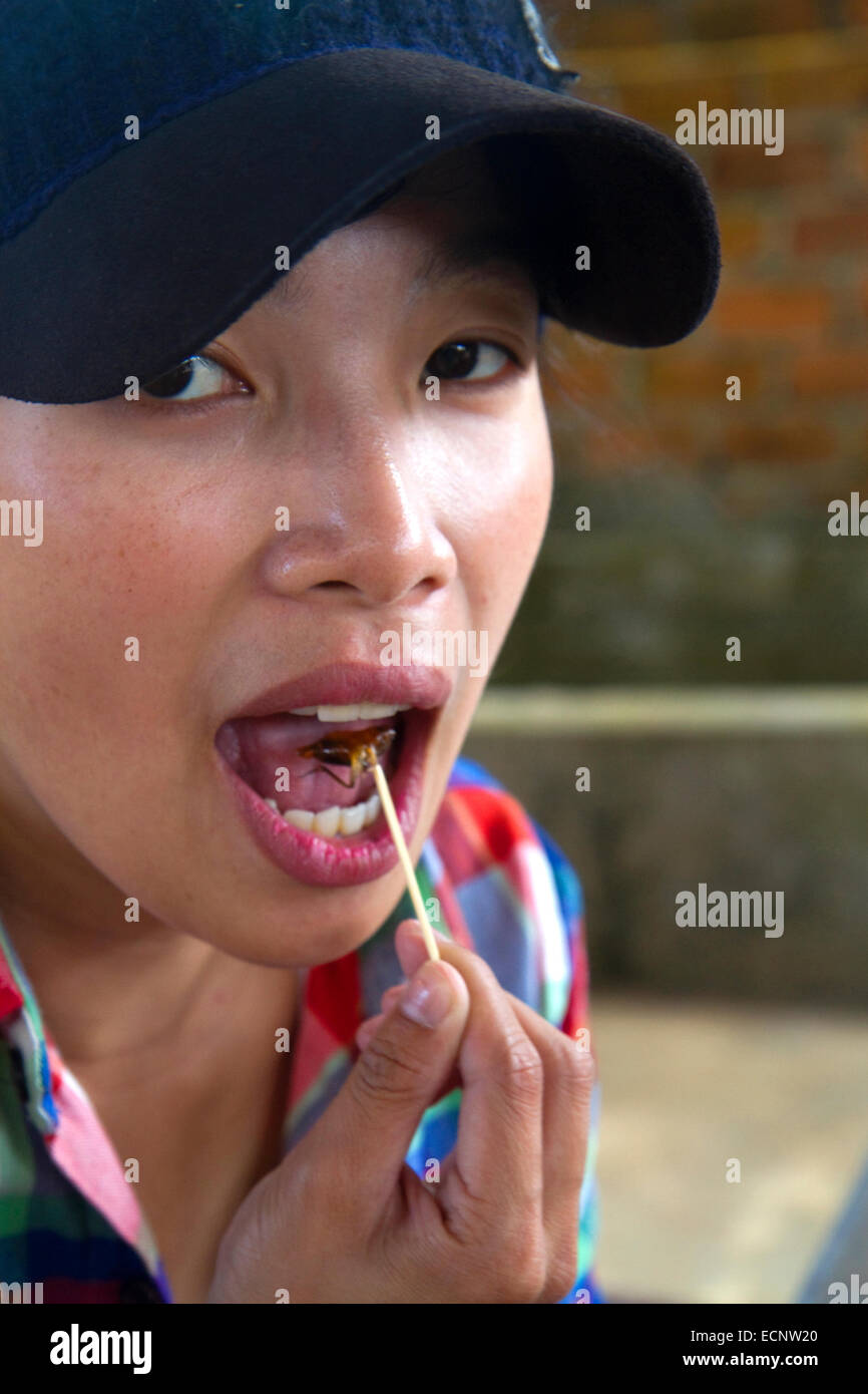 Tourists eat crickets at farm in the Lam Dong Province, Vietnam. Stock Photo