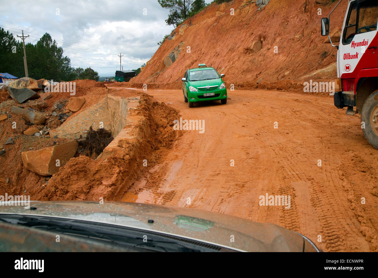 Road made of red clay at a construction site near Da Lat, Vietnam. Stock Photo