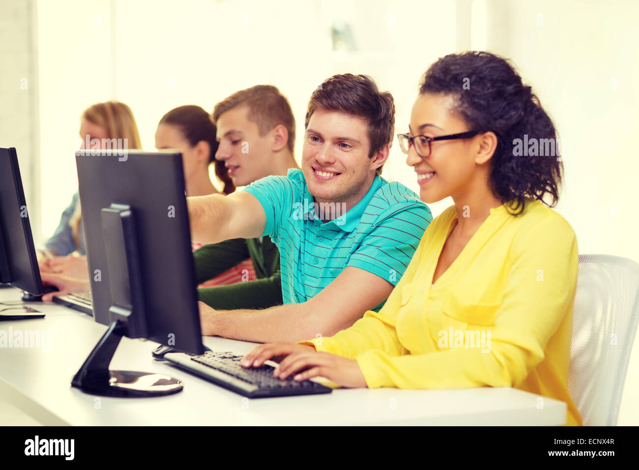 smiling students in computer class at school Stock Photo - Alamy