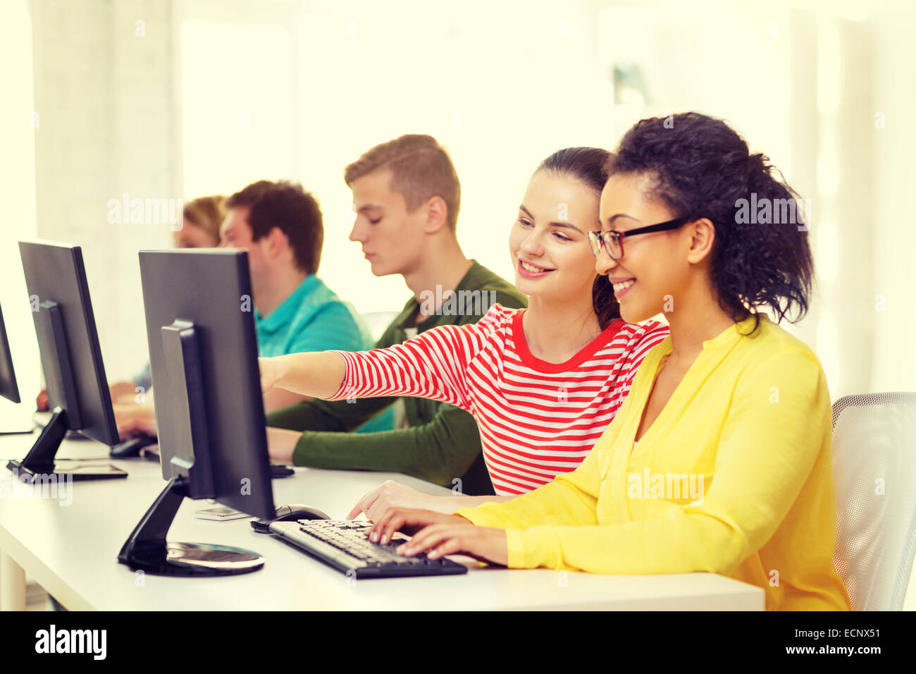 smiling students in computer class at school Stock Photo - Alamy