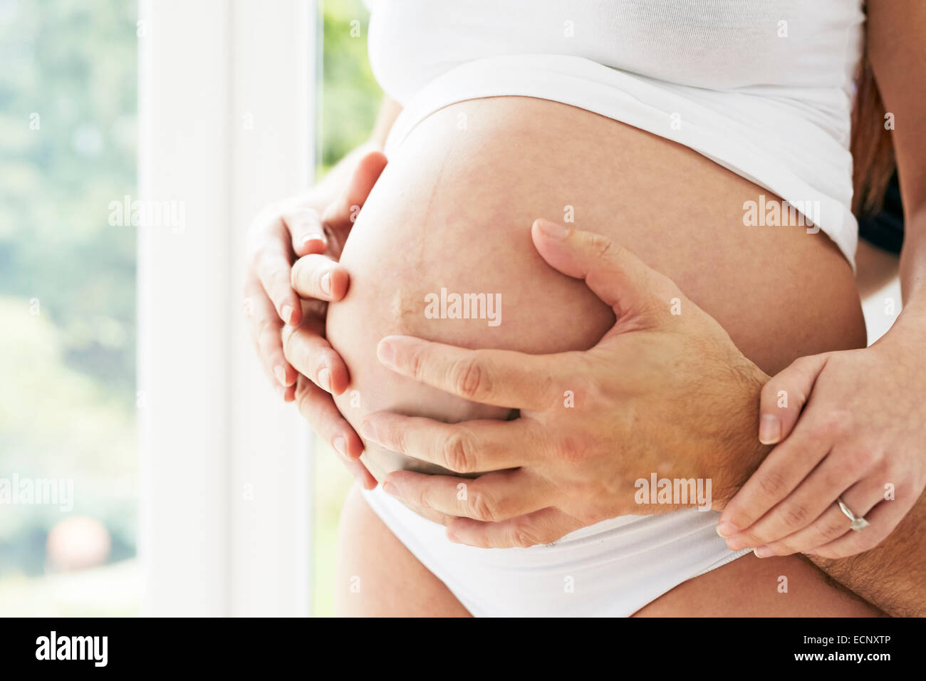 Close up of partner holding partners tummy Stock Photo