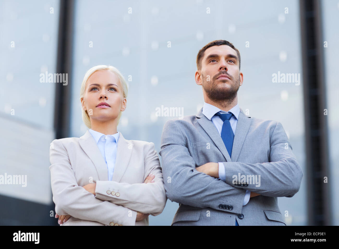 serious businessmen standing over office building Stock Photo - Alamy