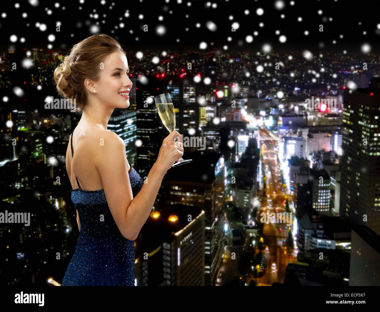smiling woman holding glass of sparkling wine Stock Photo - Alamy