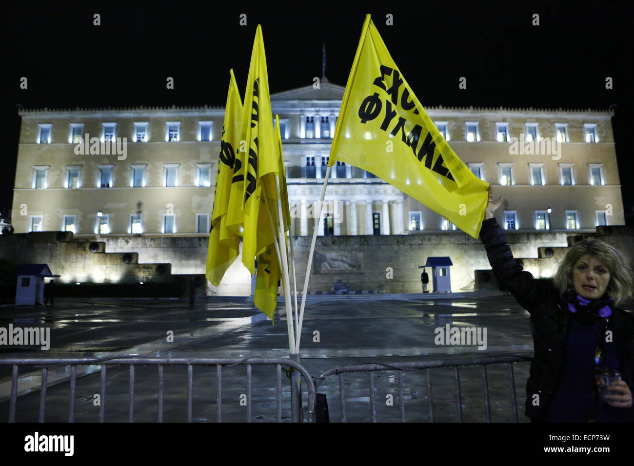 Athens, Greece. 17th December 2014. Flags from the laid off school guards fly outside the Greek Parliament. Greeks opposed to the current government protested outside the Parliament while the parliamentarians inside went to the ballot box for the first ballot of the Greek Presidential election. The governmental candidate got only 160 of the required 200 votes. Credit:  Michael Debets/Alamy Live News Stock Photo