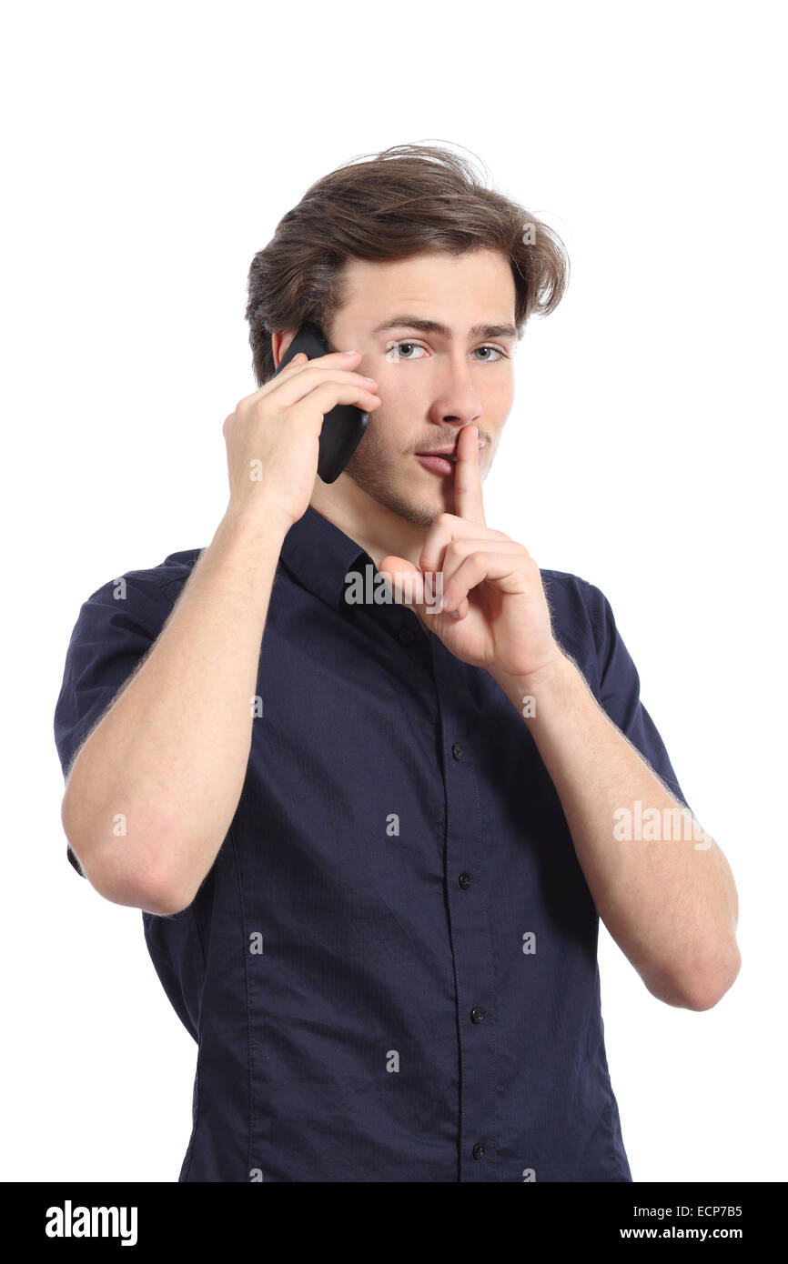 Man asking for silence with finger on lips while is calling on the phone isolated on a white background Stock Photo