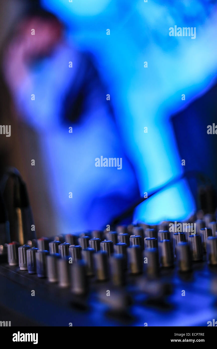 Stage light controls in front field view with blurred comedian ...
