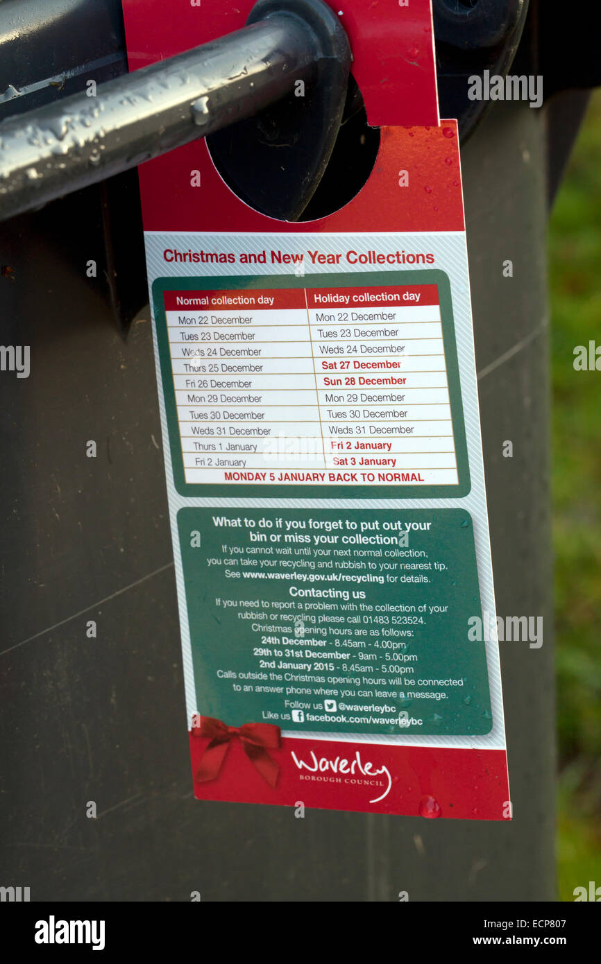 Notice hanging on notice on a wheelie bin showing Christmas and new