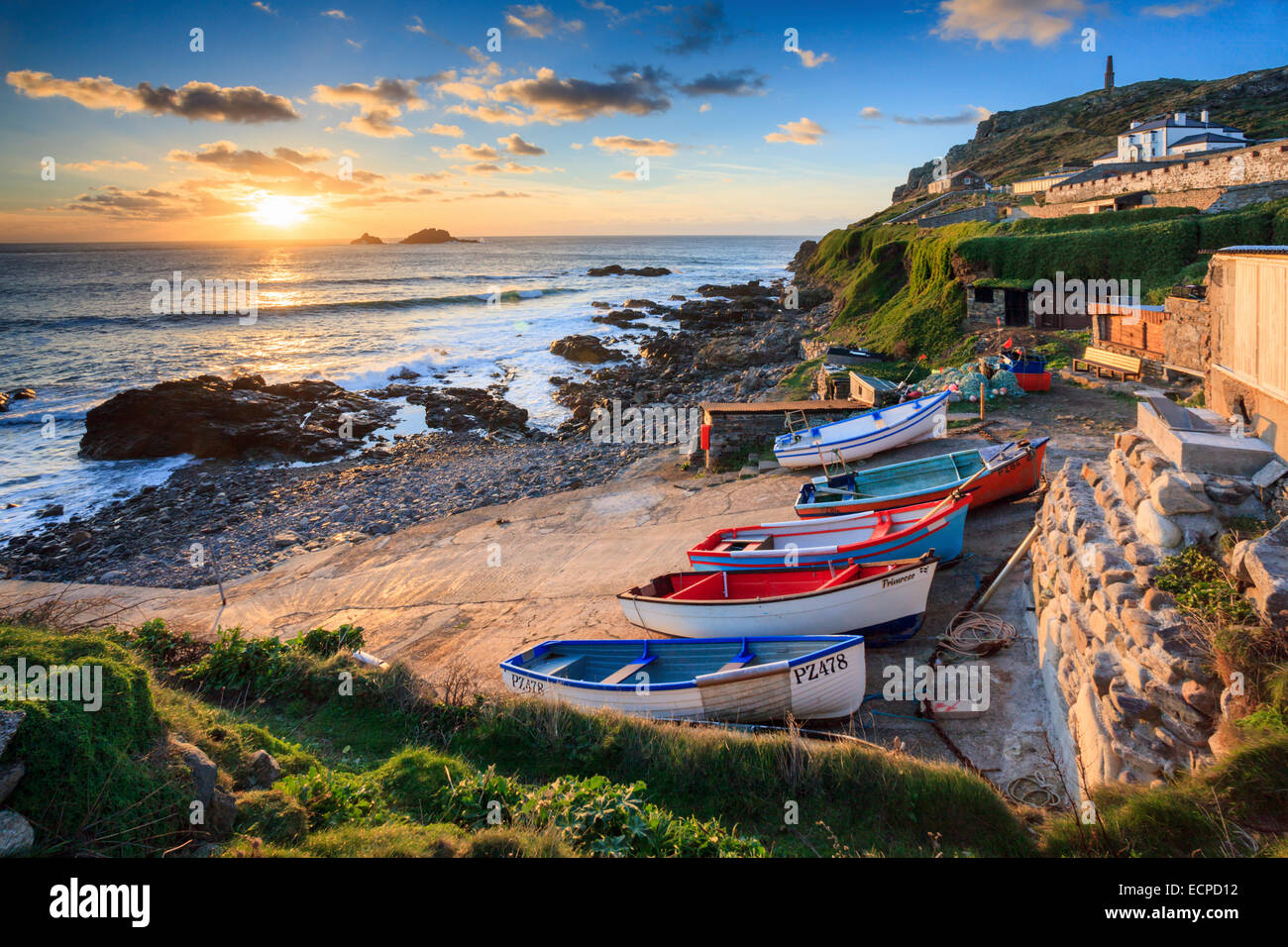 Boats at Priest's Cove captured at sunset with Cape Cornwall and the Brison Rocks in the distance. Stock Photo