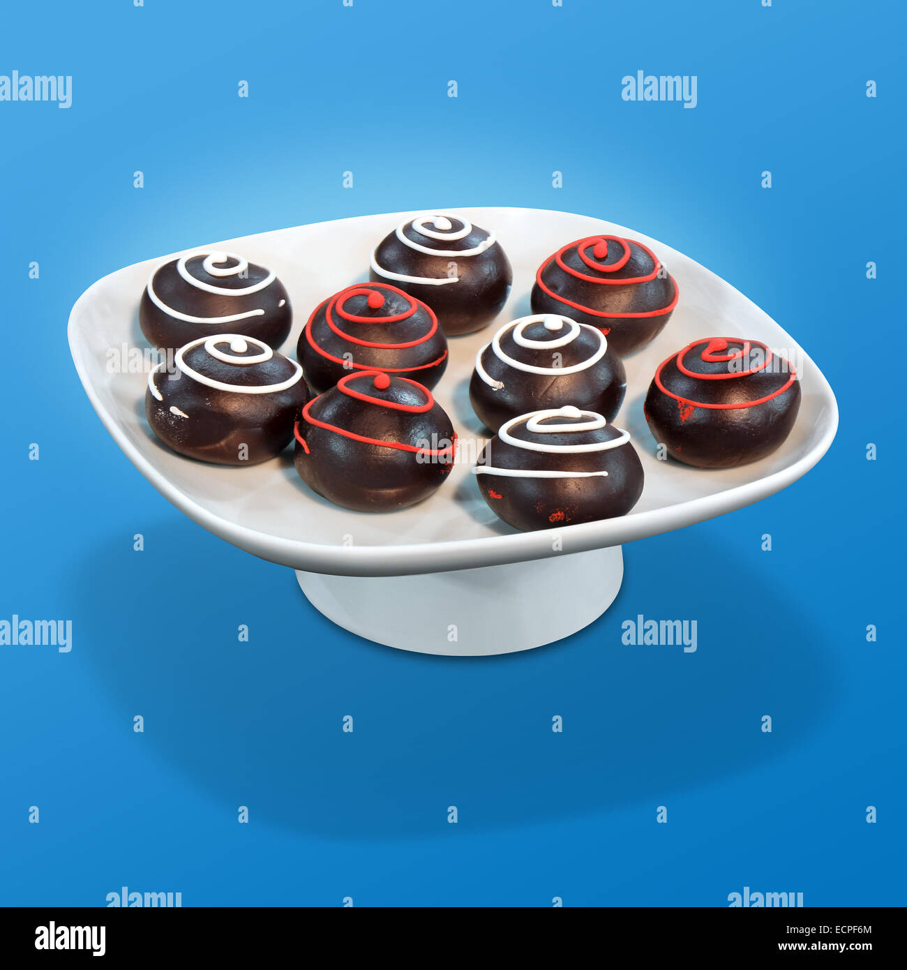 Chocolate balls Sweet dessert on a white bowl and a blue background Stock Photo