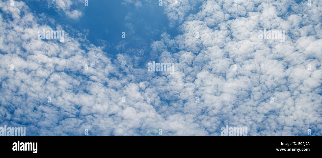 The blue sky and white fluffy clouds Stock Photo - Alamy