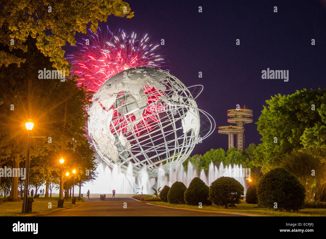 Fireworks explode over Queens' Unisphere in celebration of the 50th Anniversary of the 1964 World's Fair. Stock Photo