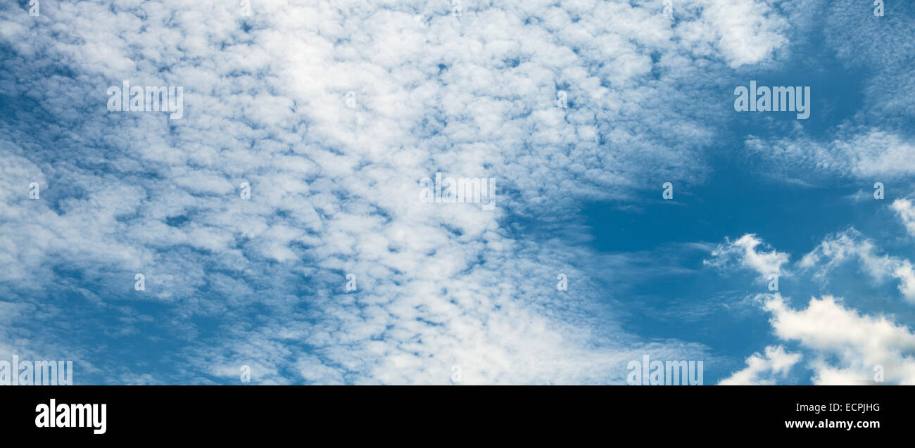 The blue sky and white fluffy clouds Stock Photo - Alamy